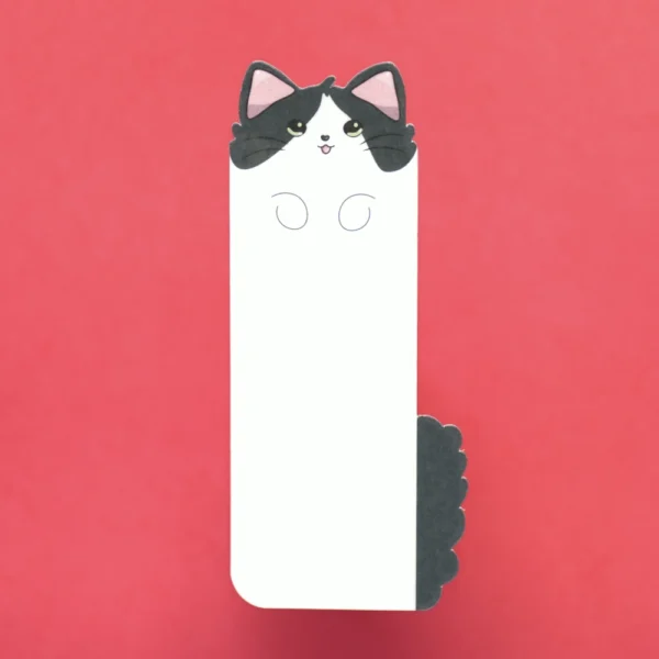 A simple long bookmark in the shape of a white and grey cat.