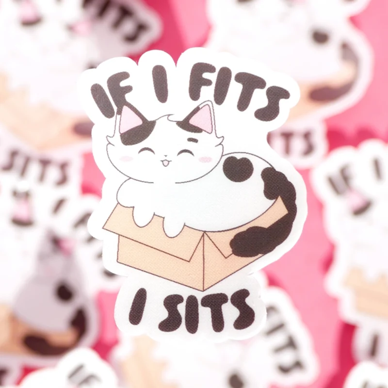 A sticker design of a cat in a box with the text if I fits, I sits.