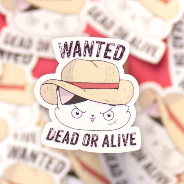 A sticker of a cat with a straw hat with the words wanted, dead or alive. Looks like Luffy from the manga One Piece.