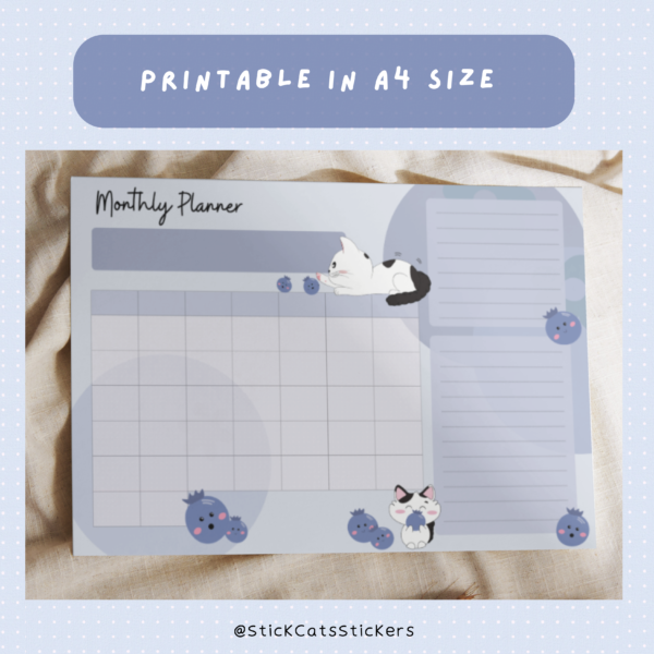 A mock up of an empty undated planner template. A cat is playing with a blueberry.