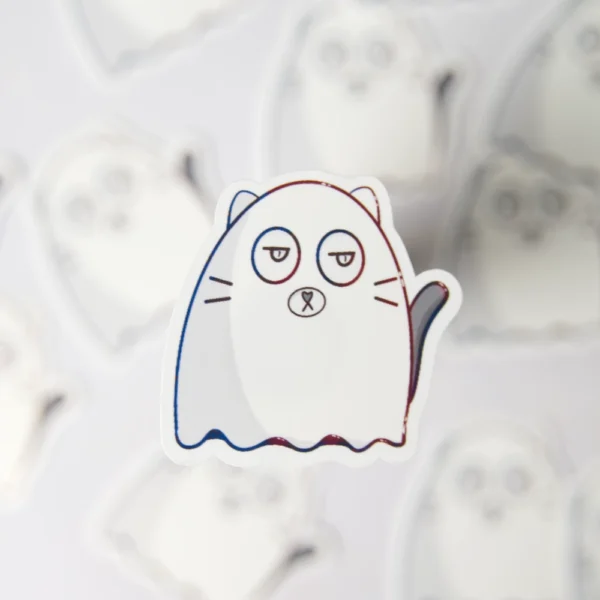 A cat ghost sticker in focus. the cat is white with a white sheet over it