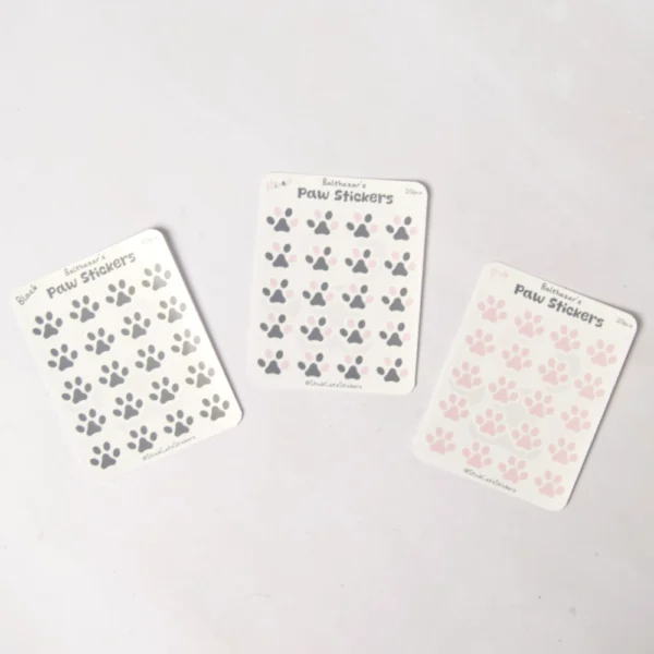 three variants of the mini paw sticker sheet. black, mixed and pink colors