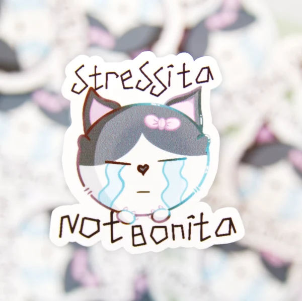 Sticker of a crying cat with teary eyes and the phrase “stressita not bonita” written above it.