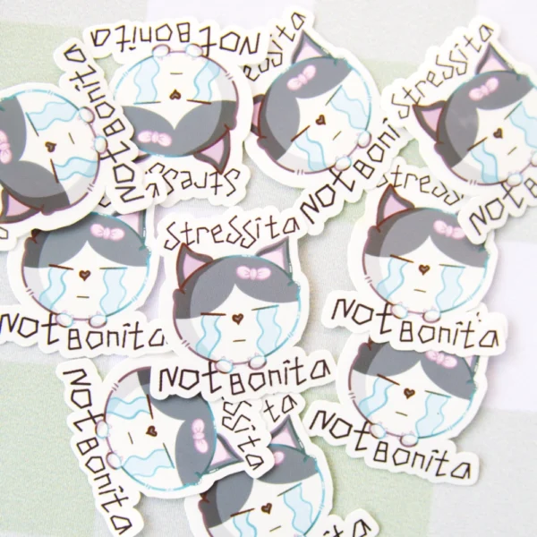Several stickers of a crying cat with teary eyes and the phrase “stressita not bonita” written above it.