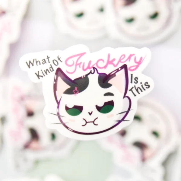 A sticker of a cat not looking content with the words what kind of fuckery is this.