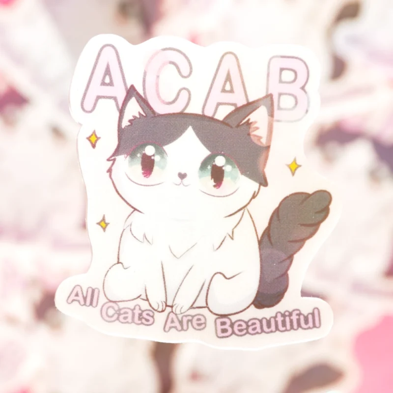 A sticker of a cute cat with the words ACAB above it. All cats are beautiful it says underneath the cat.
