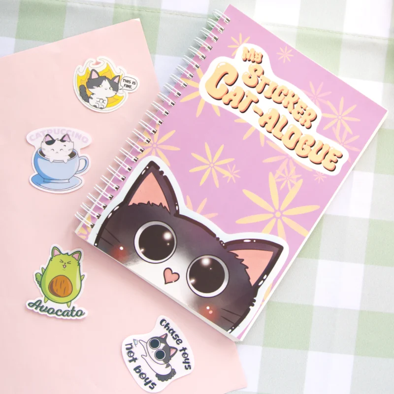 Purple sticker book featuring a cute illustrated cat on the cover, surrounded by flowers and playful design elements.